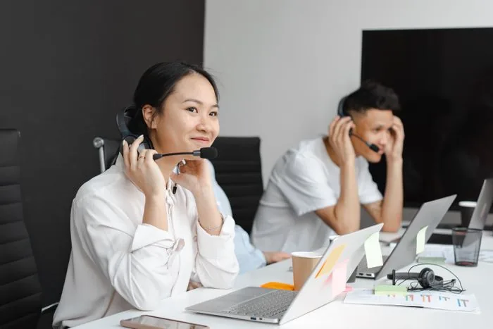 A sales rep wearing a headset on a call