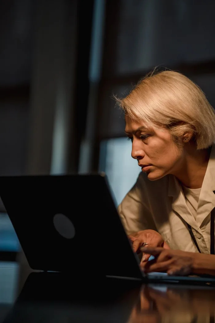 A founder working late reviewing outreach replies on a laptop