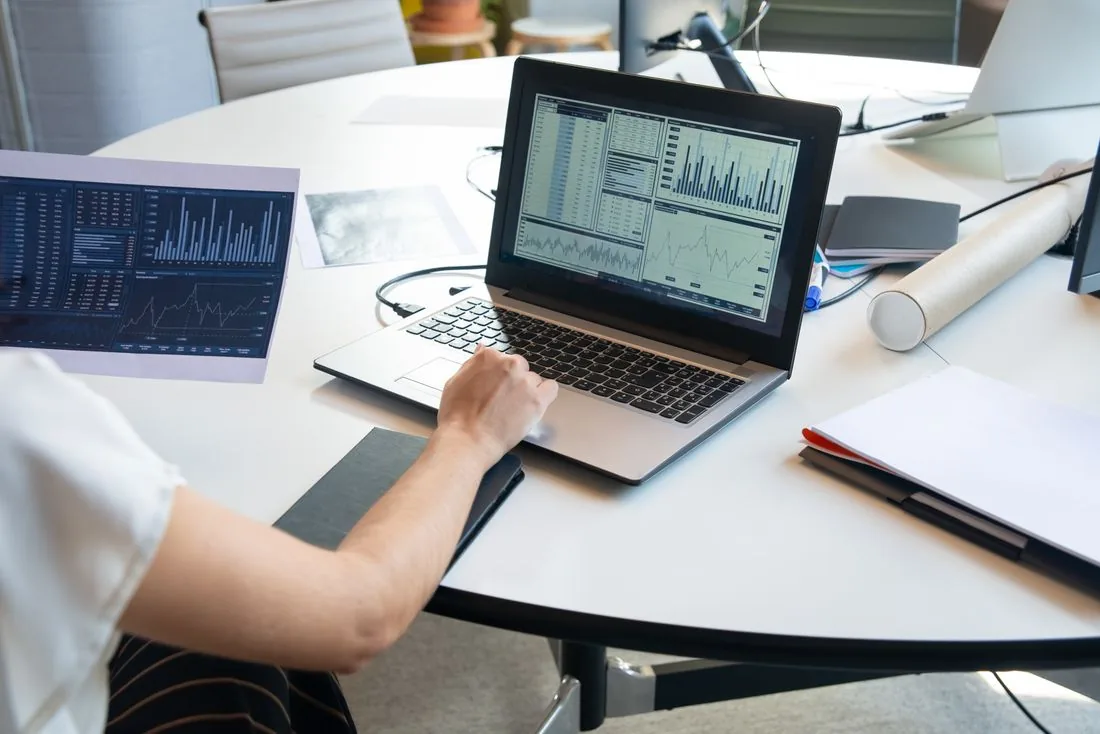 Charts and figures on a monitor in a dim office