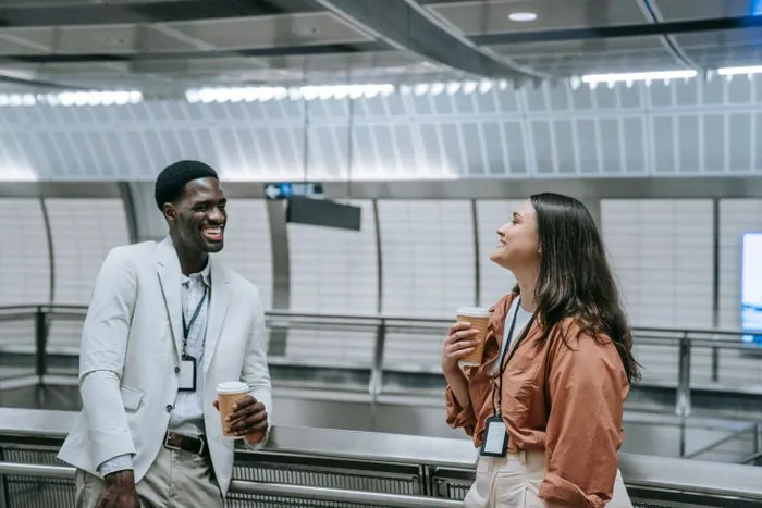 Two professionals in conversation over coffee