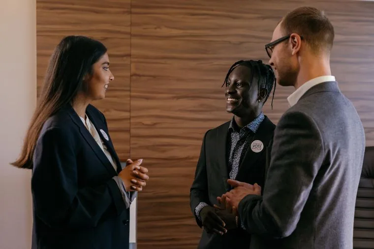 Three colleagues discussing work in a modern office