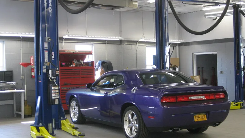 A car on the lift in an independent auto repair shop